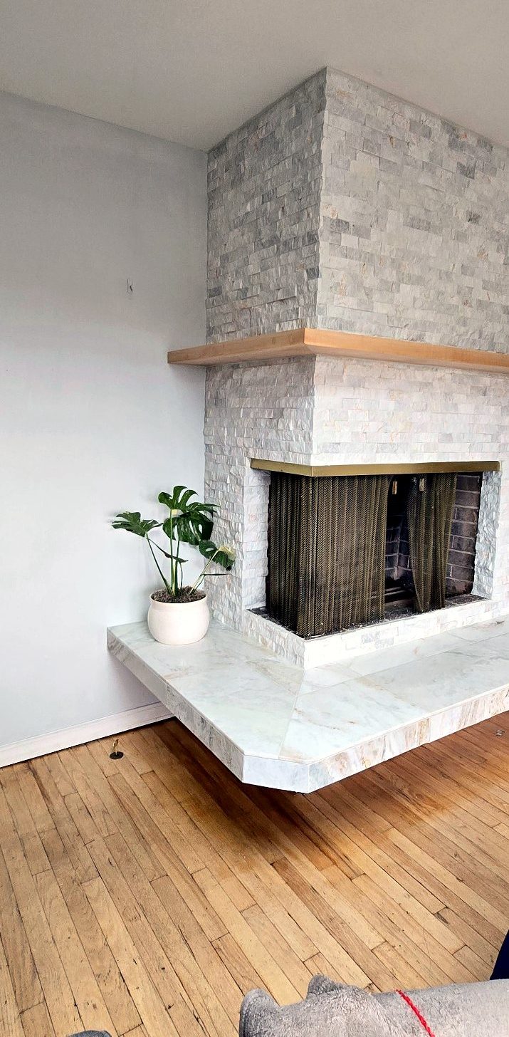 Finished Portland fireplace with manufactured stone ledger, hardwood shelf and porcelain hearth tile
