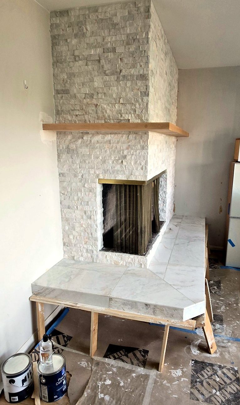 Portland fireplace nearly complete with stone ledger, hardwood shelf and porcelain hearth