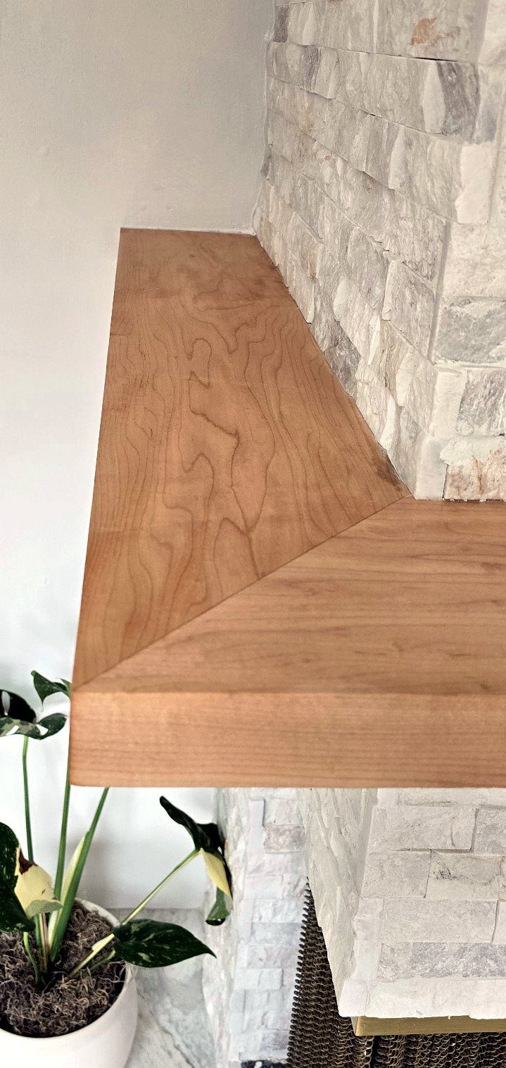 Side detail of the hardwood shelf mitered into the stone ledger