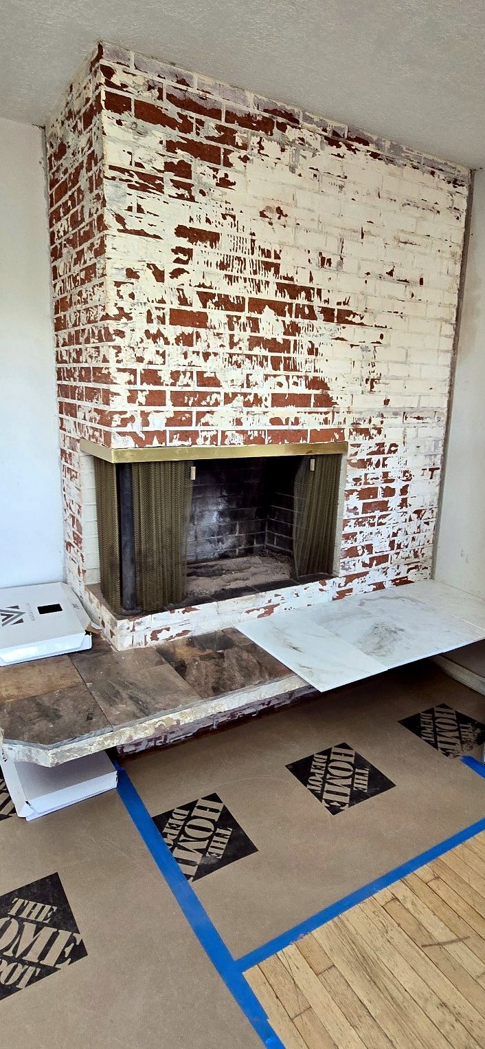 Slate removed from a Portland fireplace, exposing the painted brick underneath