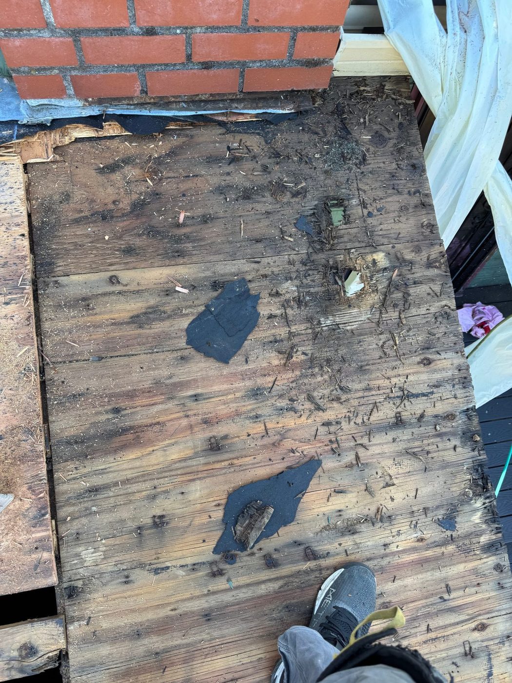 Deteriorated roof decking exposed after tear-off