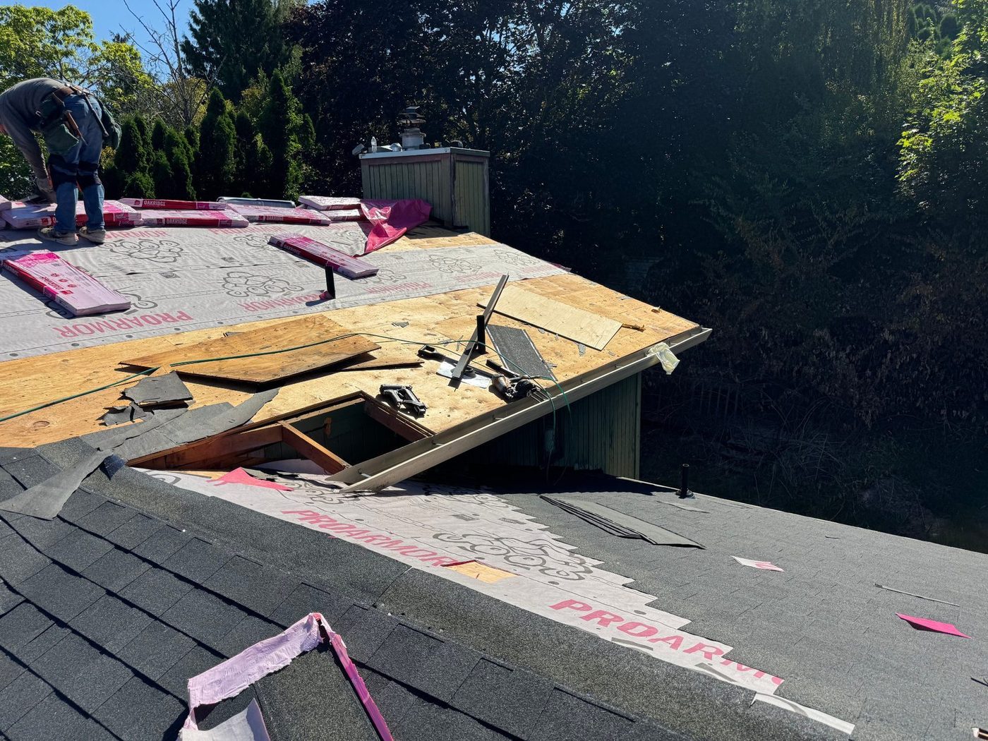Removing old shingles down to the wood deck