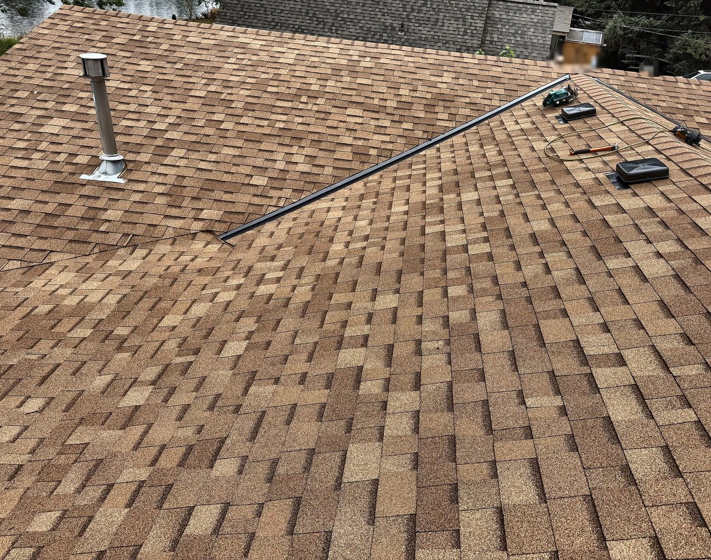 Completed Owens Corning Oakridge Desert Tan roof with new flue flashing and box vents in Columbia County, Oregon